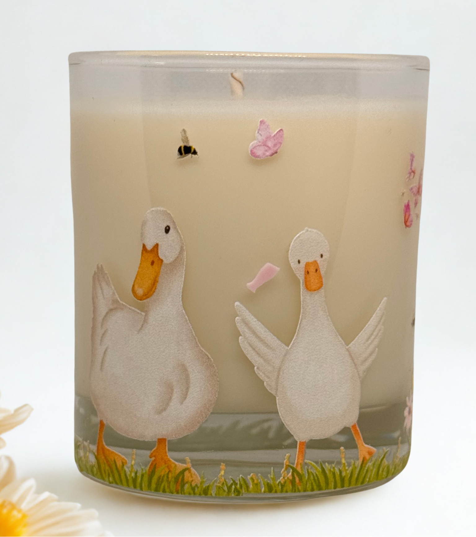 Candle with duck design on a white background